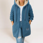 Blue longline sherpa fleece hooded jacket with cream contrast-lined hood, drawstring, and full-length zip