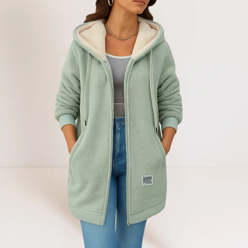 Sage green sherpa fleece hooded jacket shown open over a grey top, with cream fleece hood lining visible