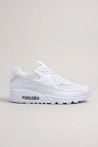 Side profile of white mesh and synthetic leather trainer with visible air-cushioned heel unit on a plain background