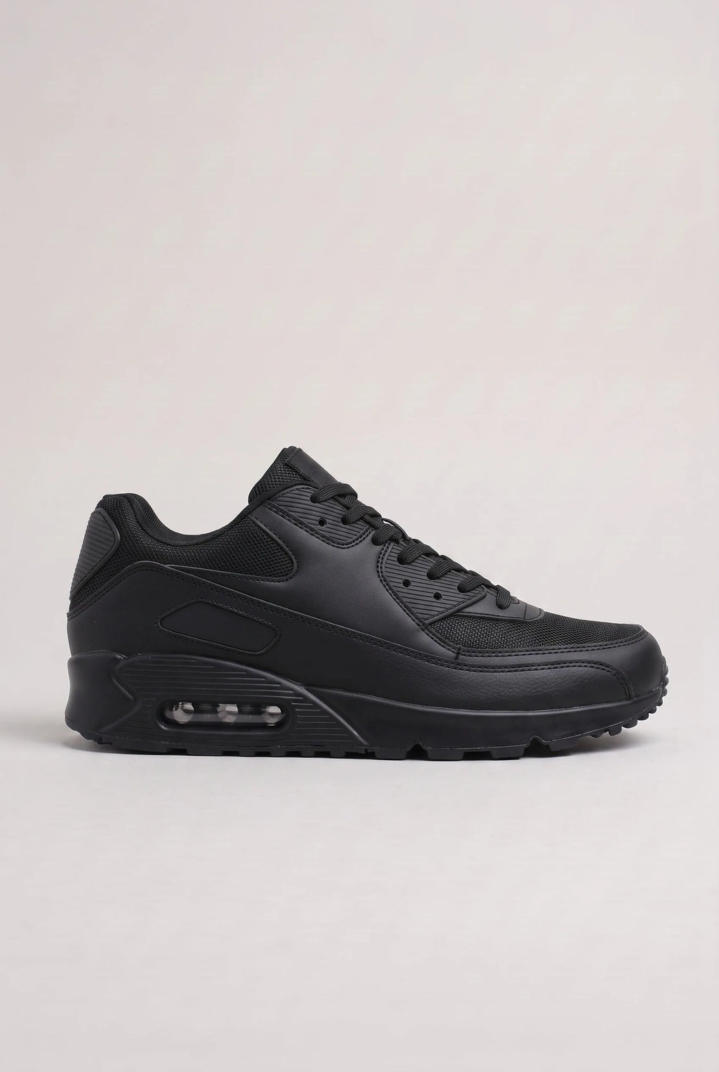 Side profile of all-black mesh and synthetic leather trainer with matching black cushioned outsole