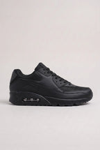 Side profile of all-black mesh and synthetic leather trainer with matching black cushioned outsole