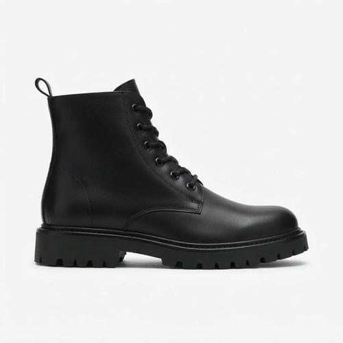 Side profile of a black leather combat boot with lace-up front, round toe and chunky lug sole on a plain background