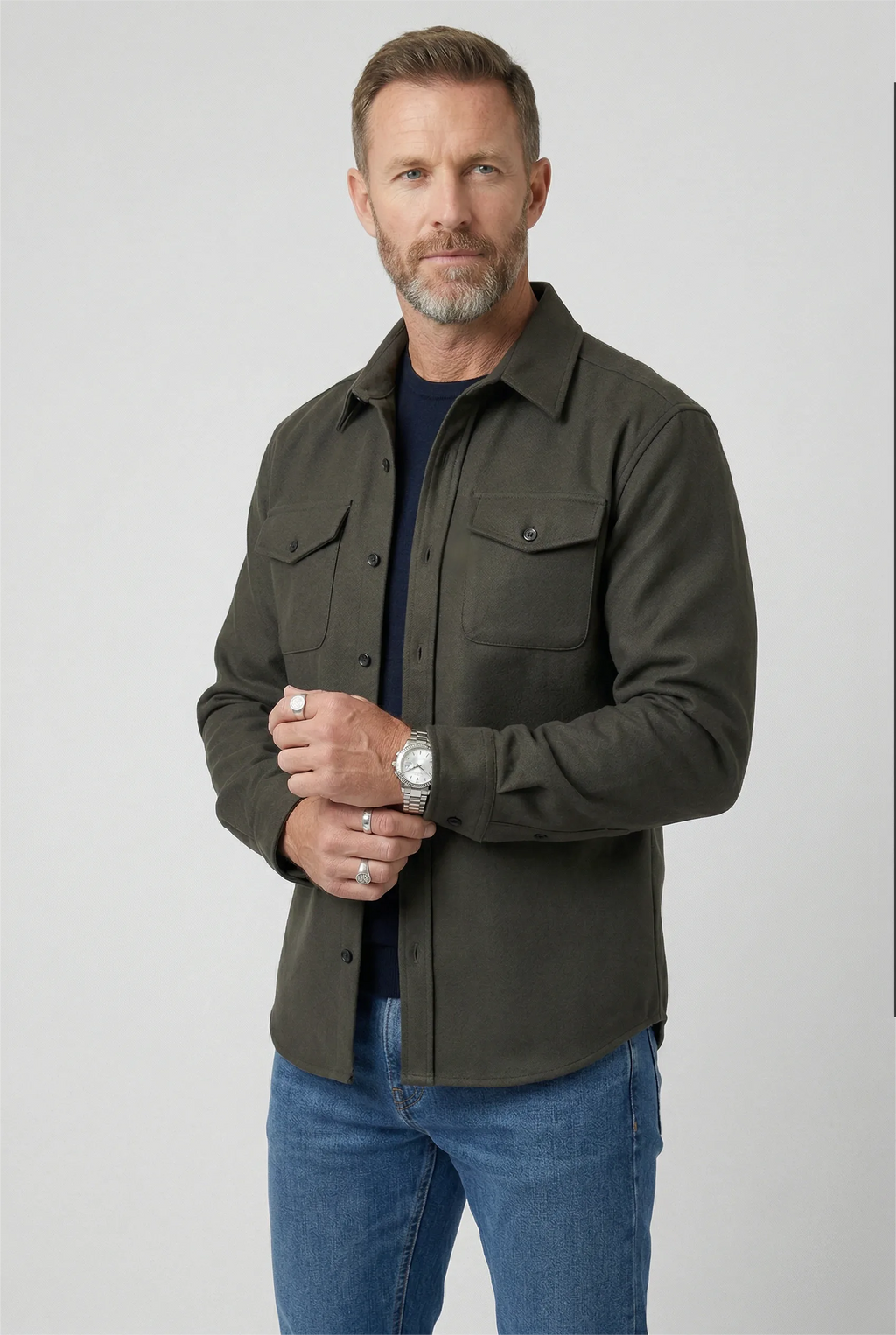Man wearing an army green brushed overshirt with chest pockets over a navy T-shirt and jeans