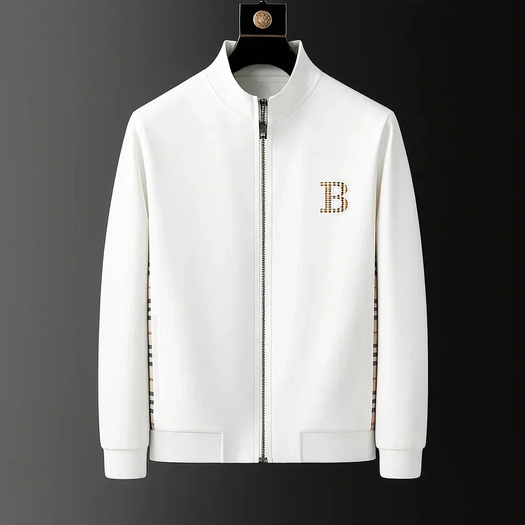 Close-up front view of white zip-through tracksuit jacket with stand collar and embroidered crest badge