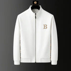 Close-up front view of white zip-through tracksuit jacket with stand collar and embroidered crest badge