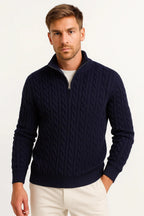 Man wearing a navy cable-knit quarter-zip jumper with ribbed collar and cuffs, front view