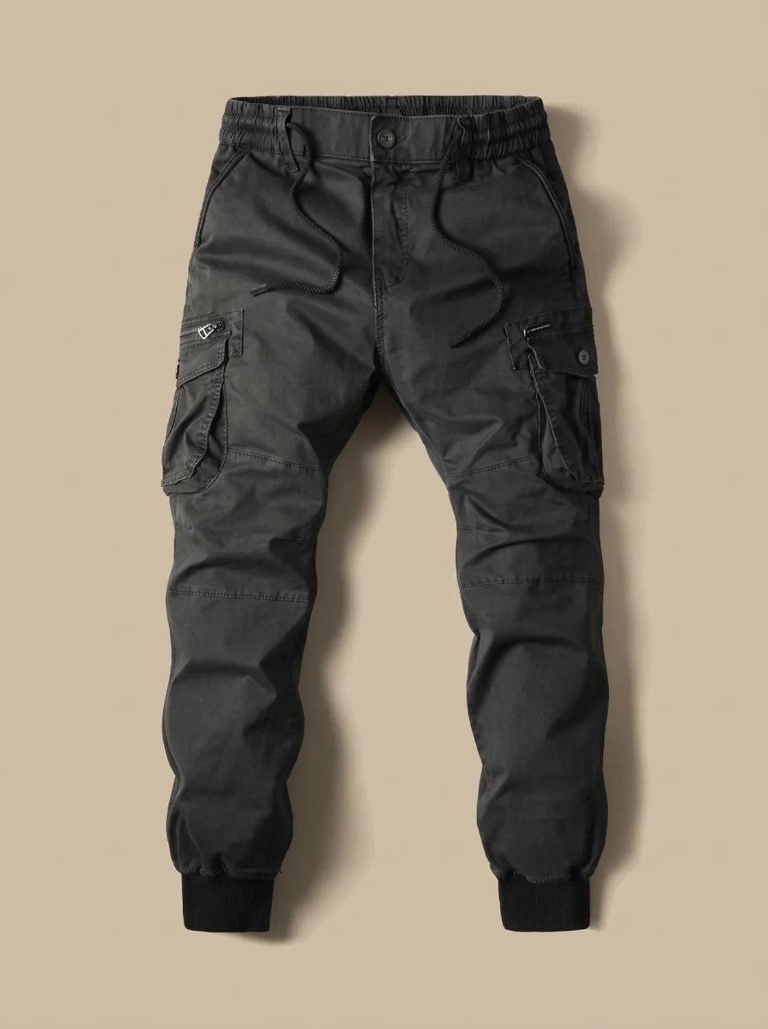 Flat lay of charcoal grey cargo joggers with ribbed ankle cuffs and twin side pockets