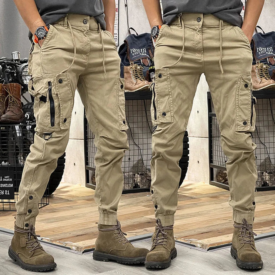 Rear and front view of men's beige cargo trousers with drawstring waist and zipped side pocket, paired with brown boots