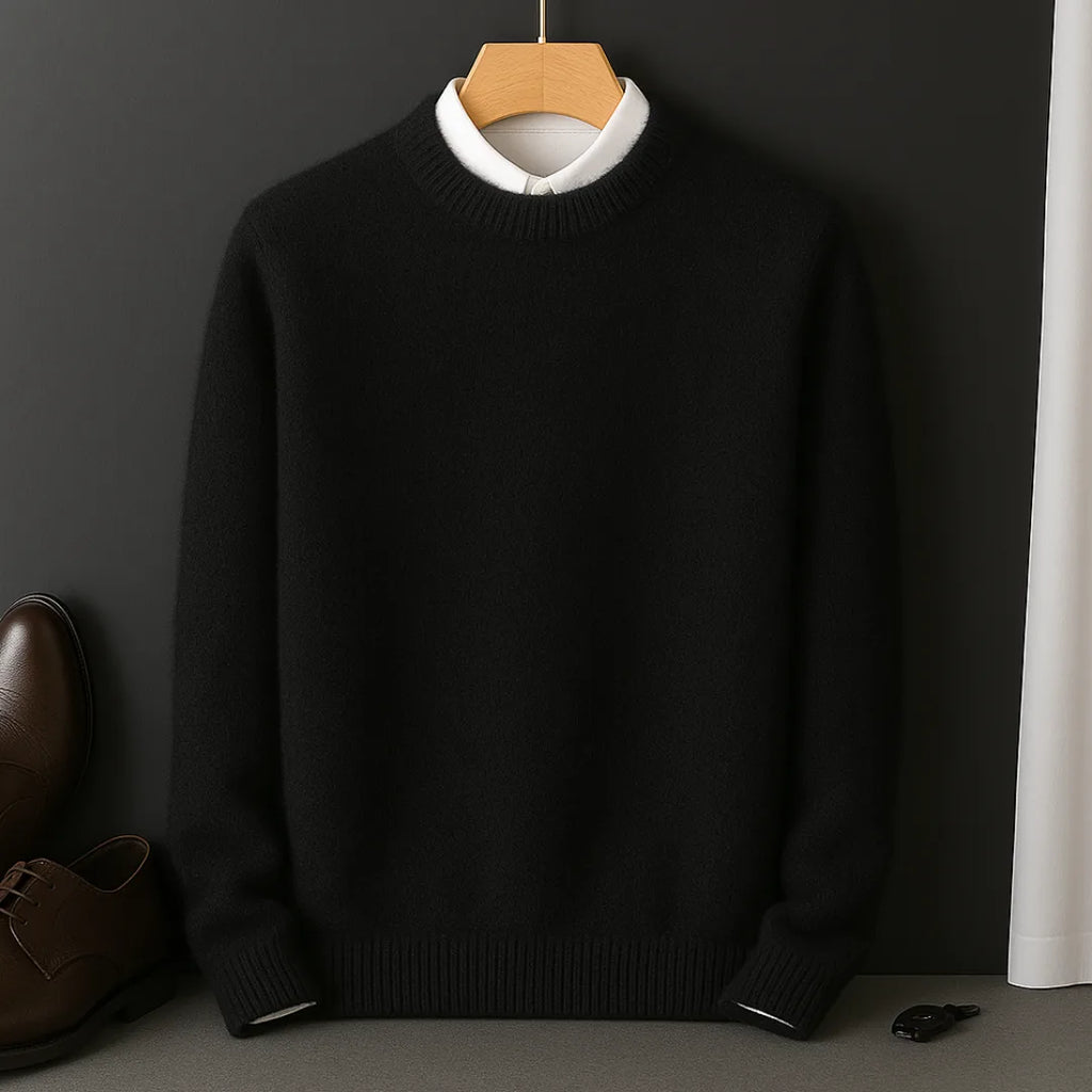 Black knitted jumper on a wooden hanger, layered over a white collared shirt, front view
