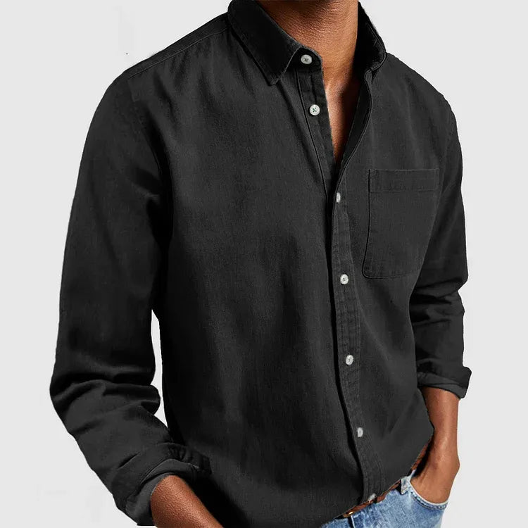 Black long sleeve button-up shirt worn open at the collar, showing the relaxed fit through the torso
