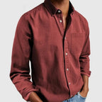 Off-white long sleeve shirt with button-down collar and chest pocket, worn with denim jeans