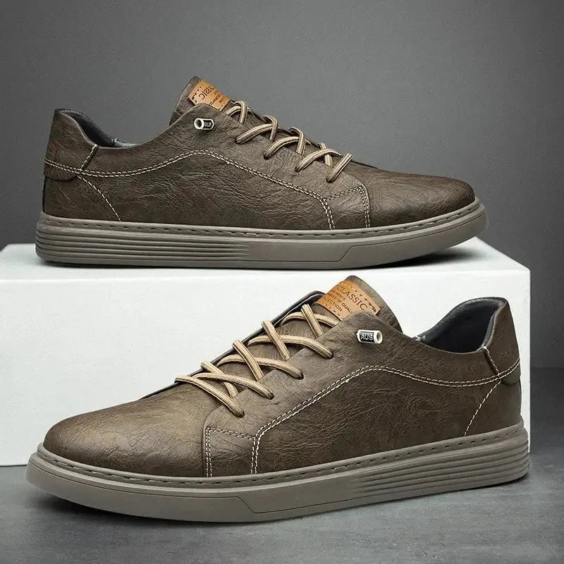 Side view of olive brown faux leather trainer with tonal laces, visible stitching detail and ridged outsole