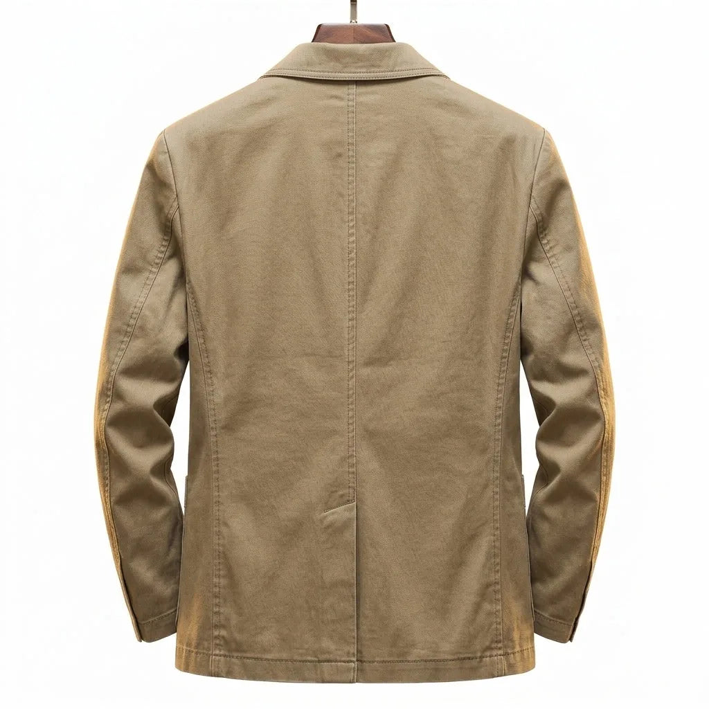 Back view of khaki cotton blazer on a wooden hanger, showing centre seam, shoulder structure and side vents