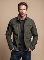 Front view of the olive green cotton jacket showing the stand collar and bronze-toned zip hardware in detail
