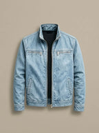 Light blue washed denim jacket laid flat, unzipped, showing stand collar and silver zip pulls