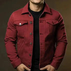 Red denim trucker jacket worn open, showing chest pockets and button placket detail