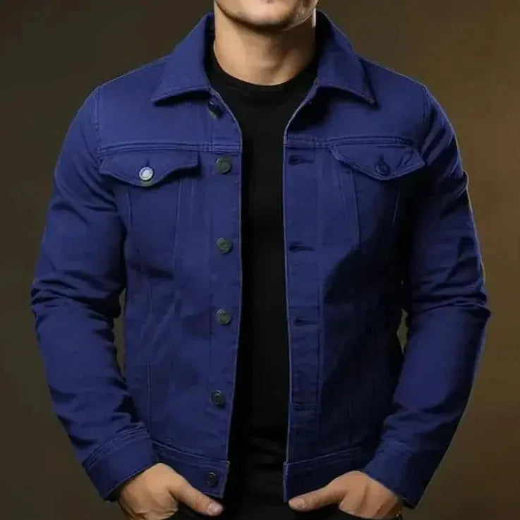 Navy denim trucker jacket buttoned to the top, close up of collar and chest pocket detail