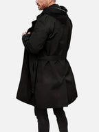 Rear view of the black trench coat with hood layered underneath, showing shoulder and back panel detail