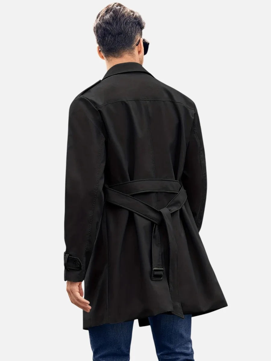 Rear view of the black trench coat showing the crossed back belt tied at the waist with buckle
