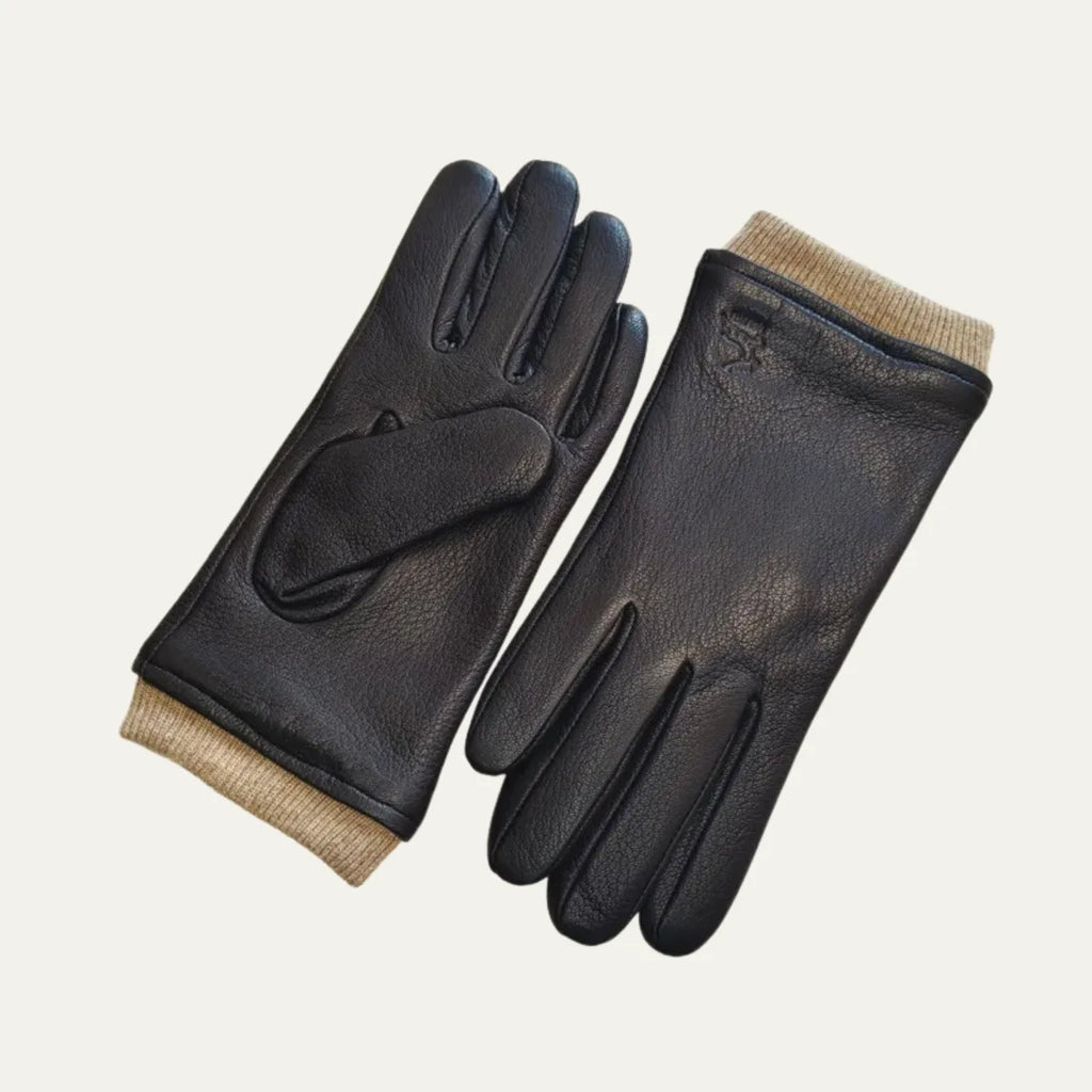 Black leather driving gloves with contrasting beige ribbed knit cuffs, shown paired flat on a plain background