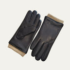 Black leather driving gloves with contrasting beige ribbed knit cuffs, shown paired flat on a plain background
