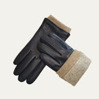 Black leather gloves laid diagonally, showcasing the full-length beige ribbed cuff folded back