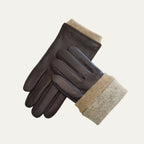 Brown leather gloves laid diagonally with the beige knitted cuff folded down to reveal its full length