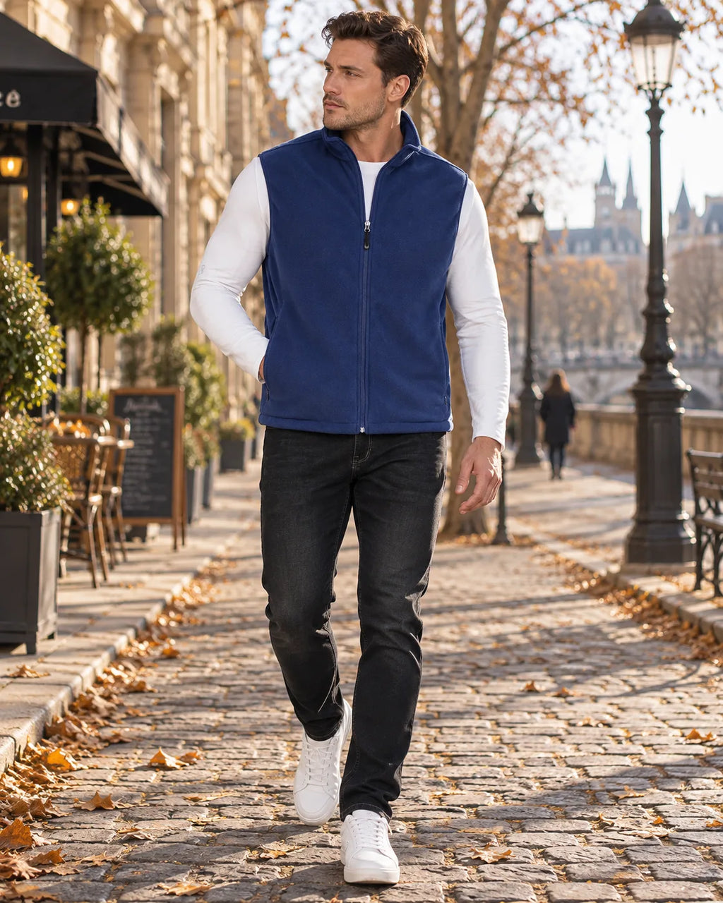 Navy blue fleece gilet with stand-up collar and zip pockets worn over white layering top with dark denim