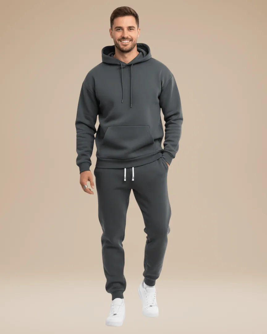 Side angle of the black tracksuit highlighting the jogger fit and ribbed ankle cuffs