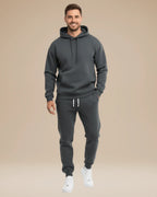 Side angle of the black tracksuit highlighting the jogger fit and ribbed ankle cuffs