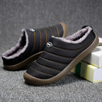 Front angle of black fleece-lined slippers showing the padded vamp and logo patch