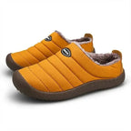 Rear three-quarter view of navy slippers displaying the textured rubber outsole tread