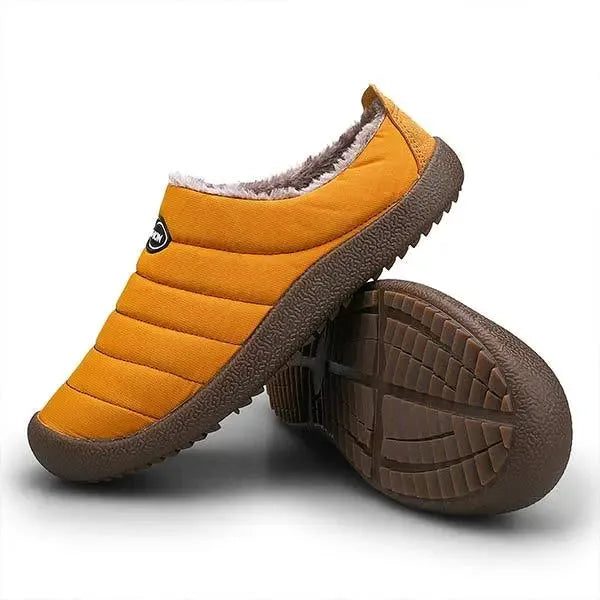 Close-up of the brown ridged non-slip sole on an olive green quilted slipper