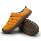 Close-up of the brown ridged non-slip sole on an olive green quilted slipper