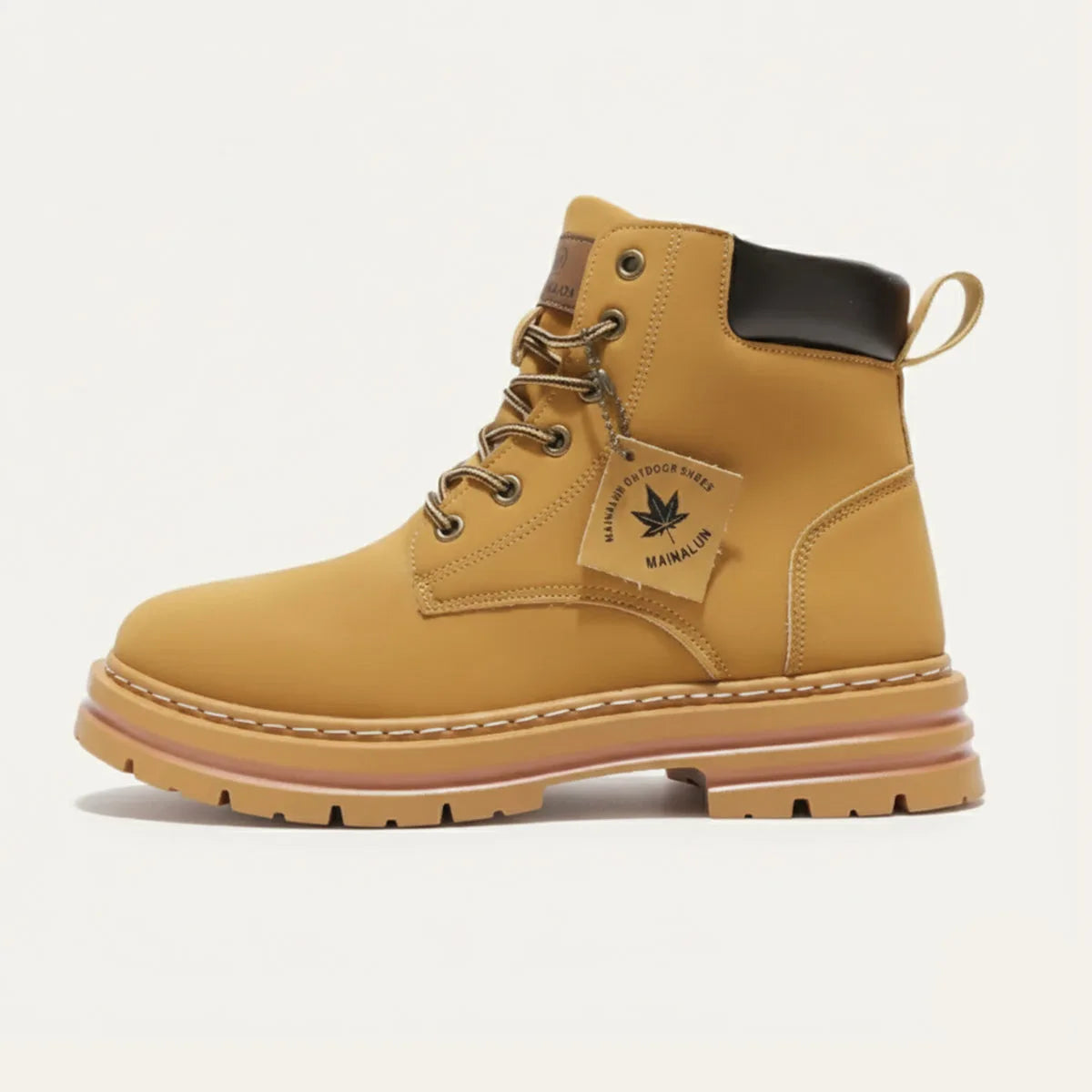 Side profile of tan nubuck lace-up boot with lugged gum sole and branded hang tag