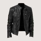 Front three-quarter view of a black leather biker jacket with stand collar, snap tabs and zip chest pockets, worn on a mannequin