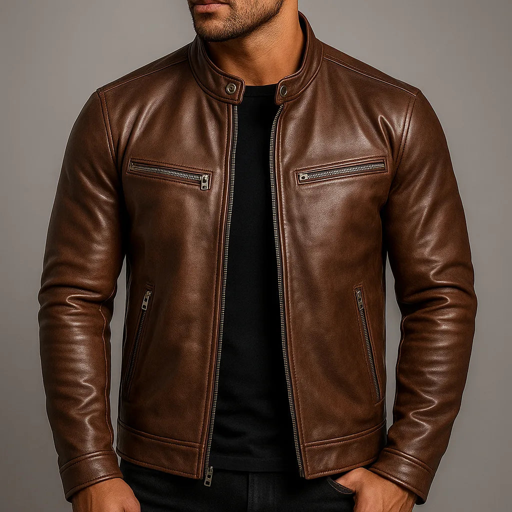Close-up of brown leather biker jacket worn by a model, showing collar snap and chest zip pocket detail