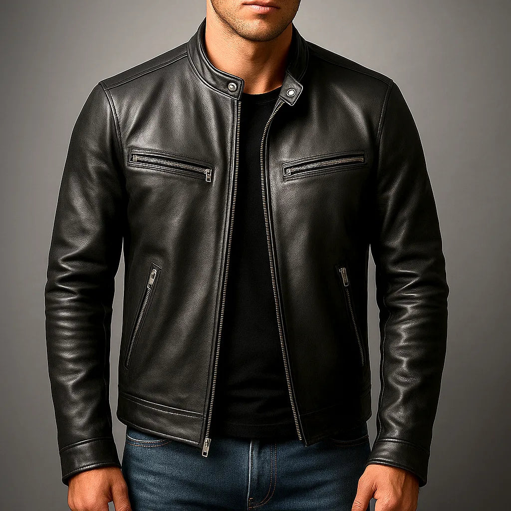 Close-up of black leather biker jacket worn by a model, showing stand collar, zip pulls and front zip