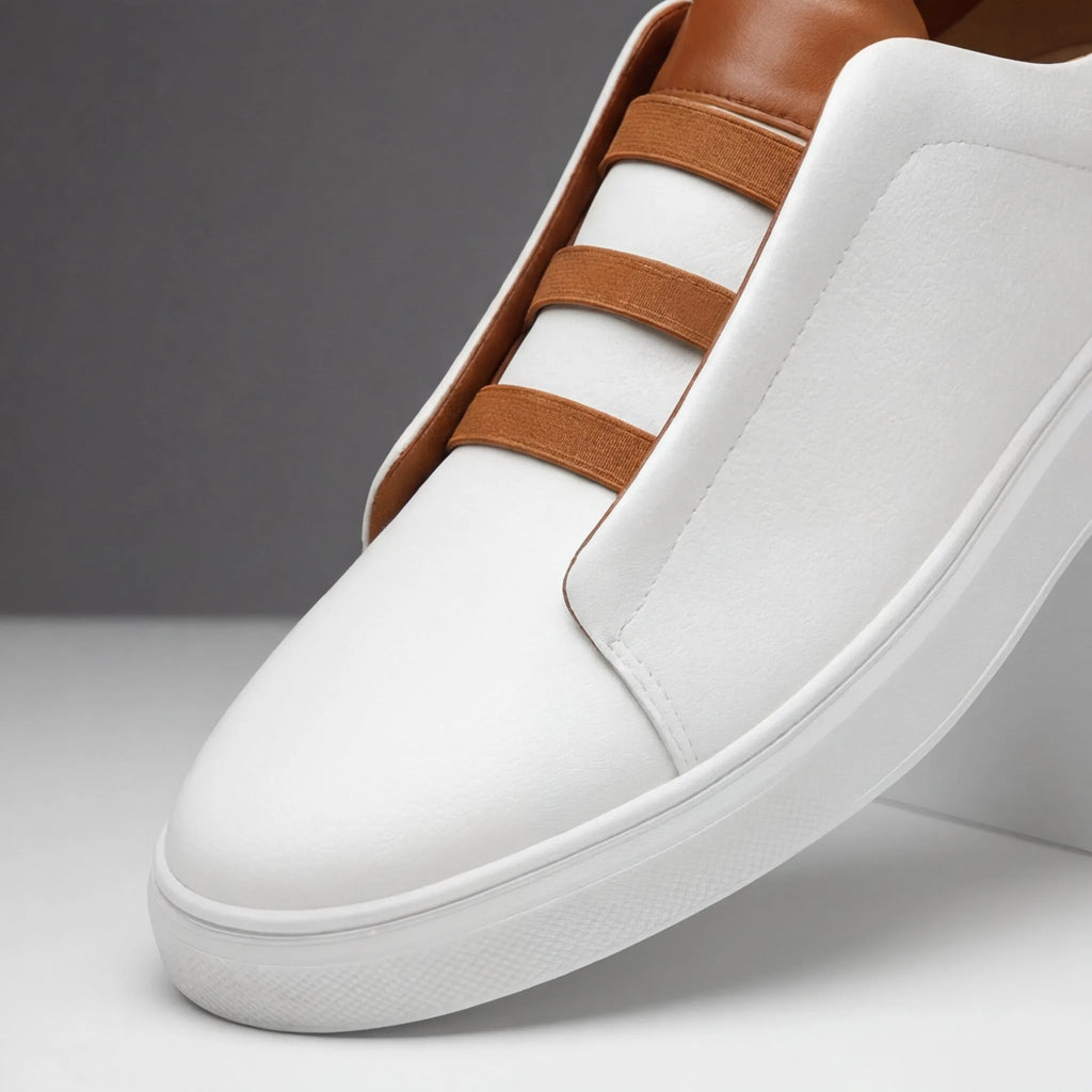 Close-up of the toe and tan loop lacing detail on a white leather slip-on trainer