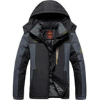 Black and grey padded ski jacket with fur-lined hood zipped up, front view showing chest pocket and zip pulls