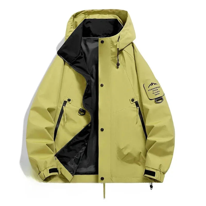 Yellow hooded jacket laid flat, unzipped showing black inner lining, zip pockets and mountain logo patch on sleeve
