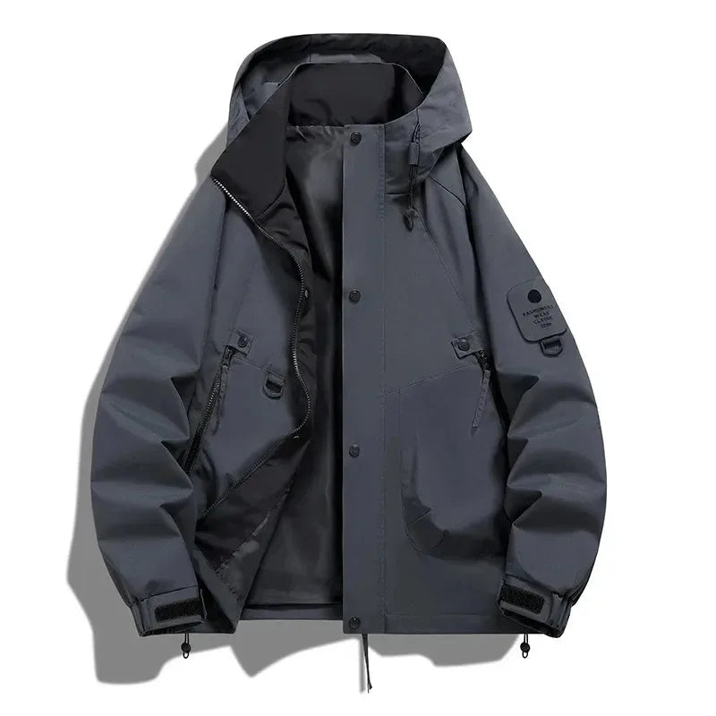 Dark grey hooded jacket laid flat, open front revealing black lining, snap buttons and dual zip chest pockets