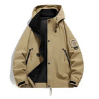 Tan hooded jacket laid flat, open front with black lining, two zip chest pockets and lower flap pocket