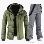 Green hooded puffer ski jacket paired with matching grey bib ski trousers with suspenders, front view