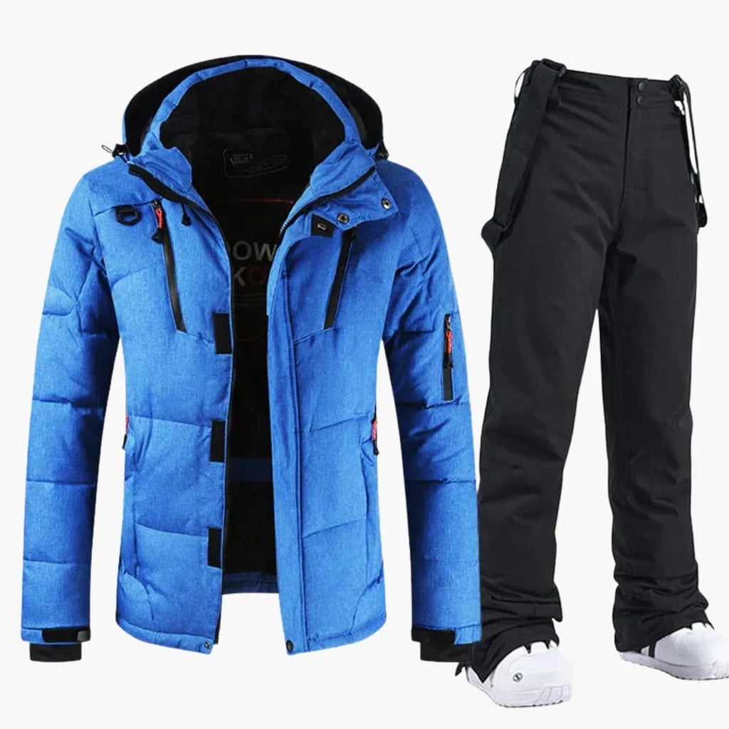 Blue quilted ski jacket with black hood lining, worn with matching black bib snow trousers