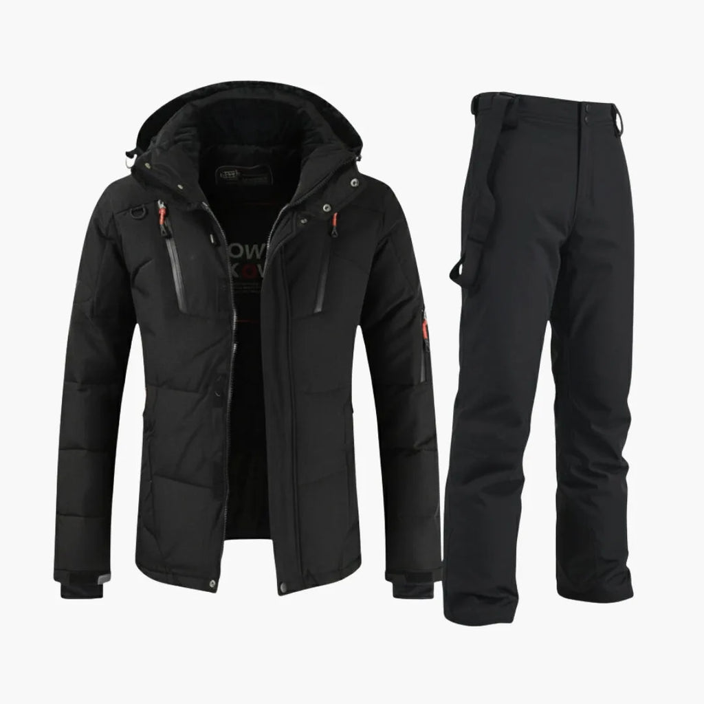 All-black hooded ski jacket with zip pockets worn with matching black bib snow trousers