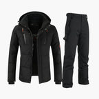 All-black hooded ski jacket with zip pockets worn with matching black bib snow trousers