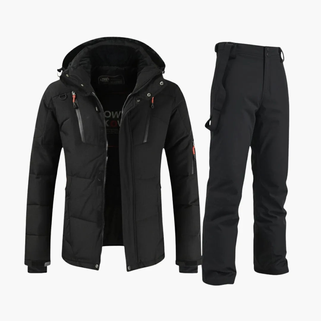All-black hooded ski jacket with zip pockets worn with matching black bib snow trousers