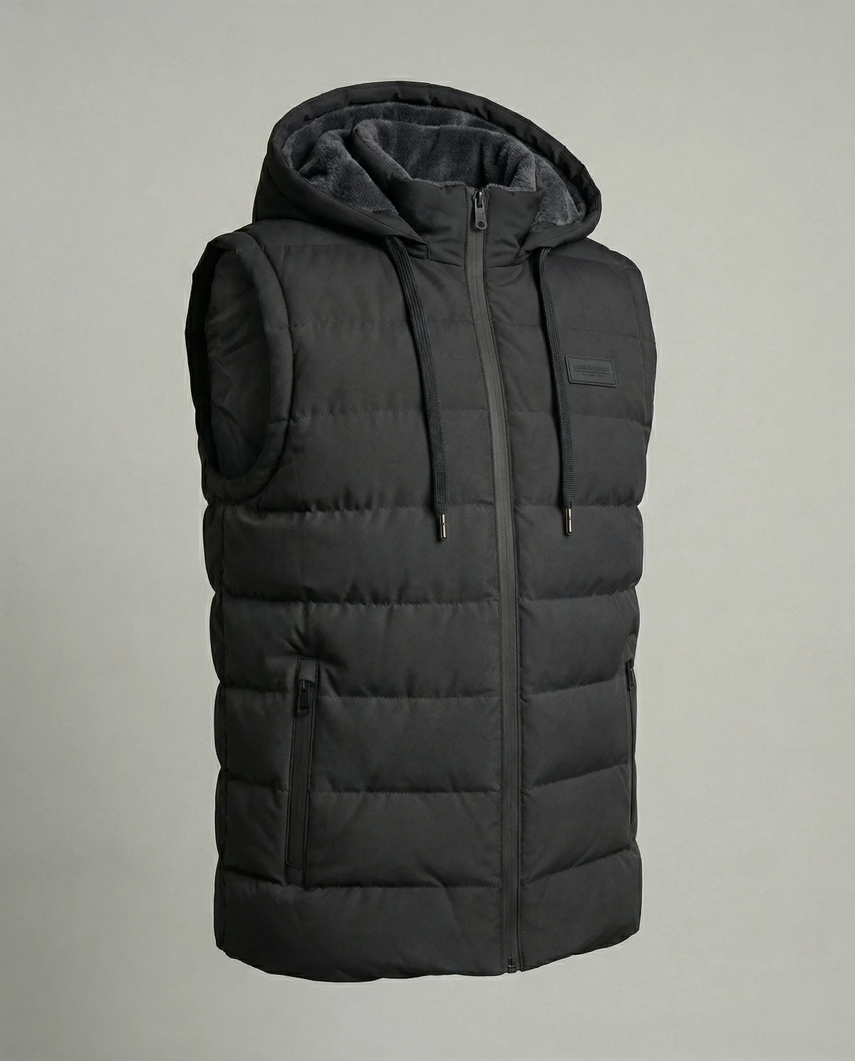 Product shot of a black quilted hooded gilet with contrast grey faux fur lined hood and zip front