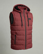 Close-up angle of a quilted hooded gilet showing the horizontal channel quilting and zip pocket detail